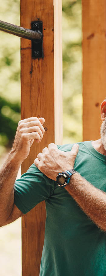 Senior man suffering with shoulder pain during workout