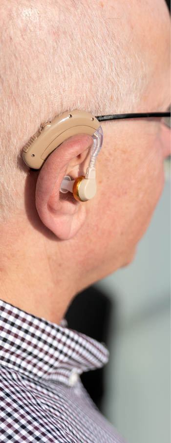 Elderly, deaf man uses a hearing aid  Two people conversation