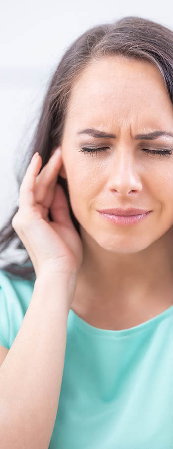 Young woman have headache migraine stress or tinnitus - noise whistling in her ears 